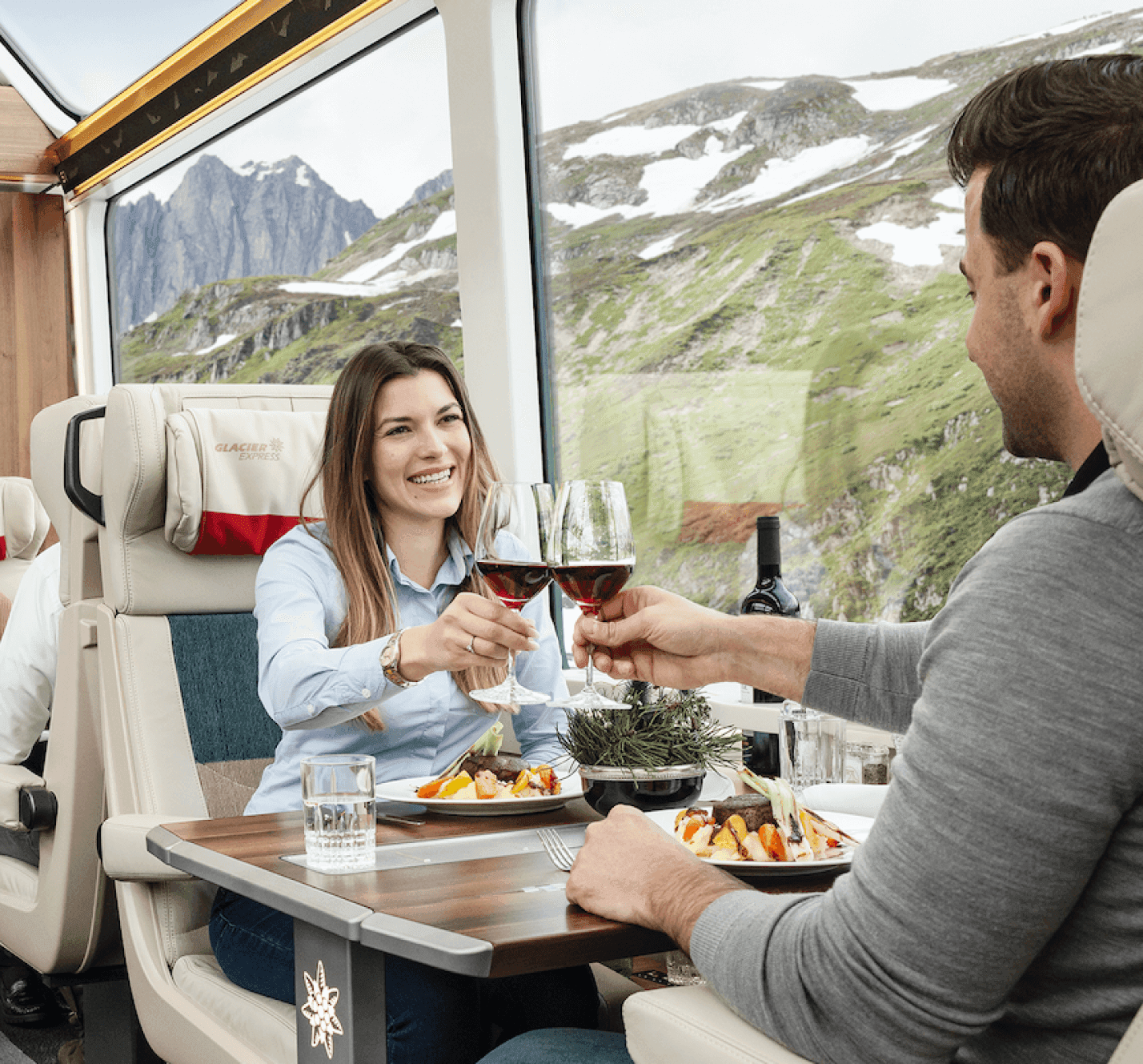 The image shows a man and a woman enjoying a meal on a boat.