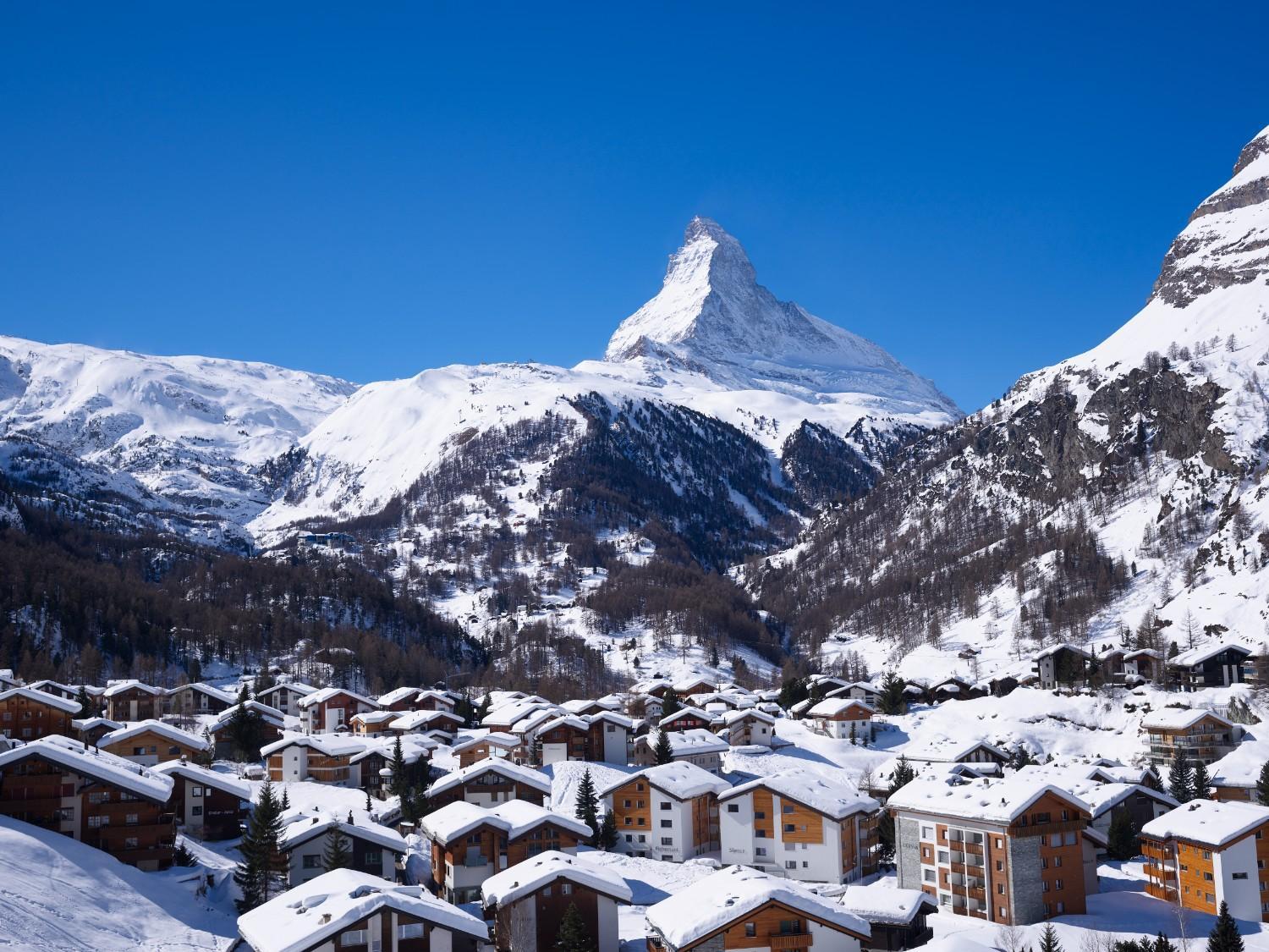 The image shows the snow-covered town of Zermatt