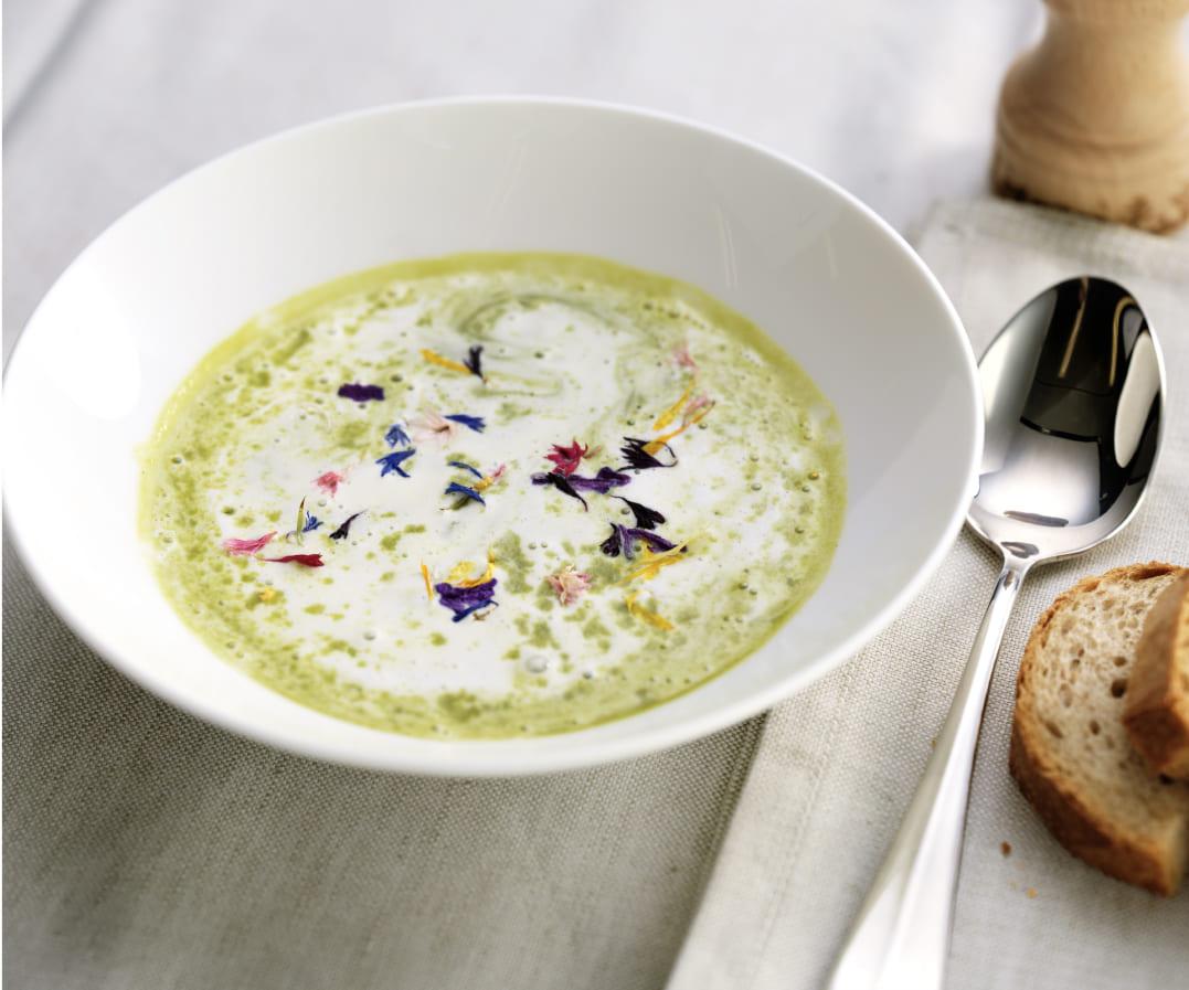 The image shows a bowl of creamy green soup.